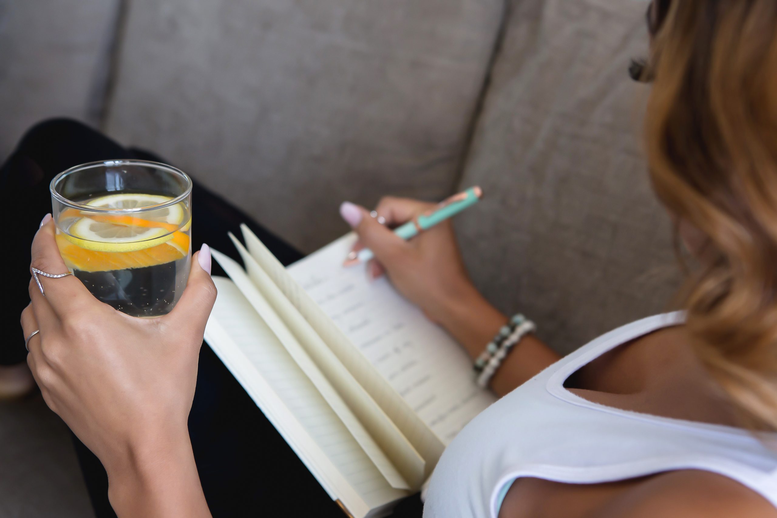 Woman drinking water and journaling
