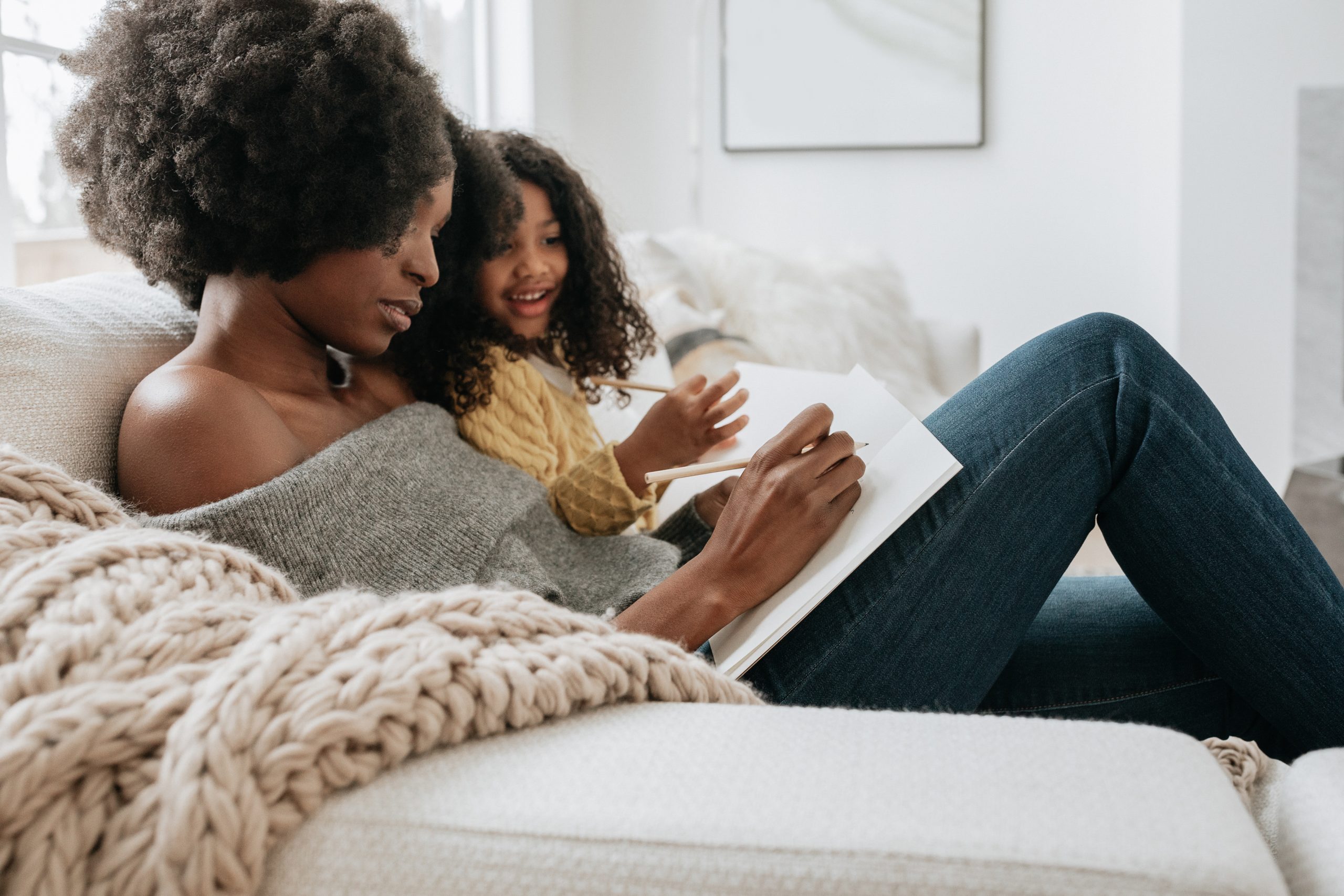 Woman and daughter journaling